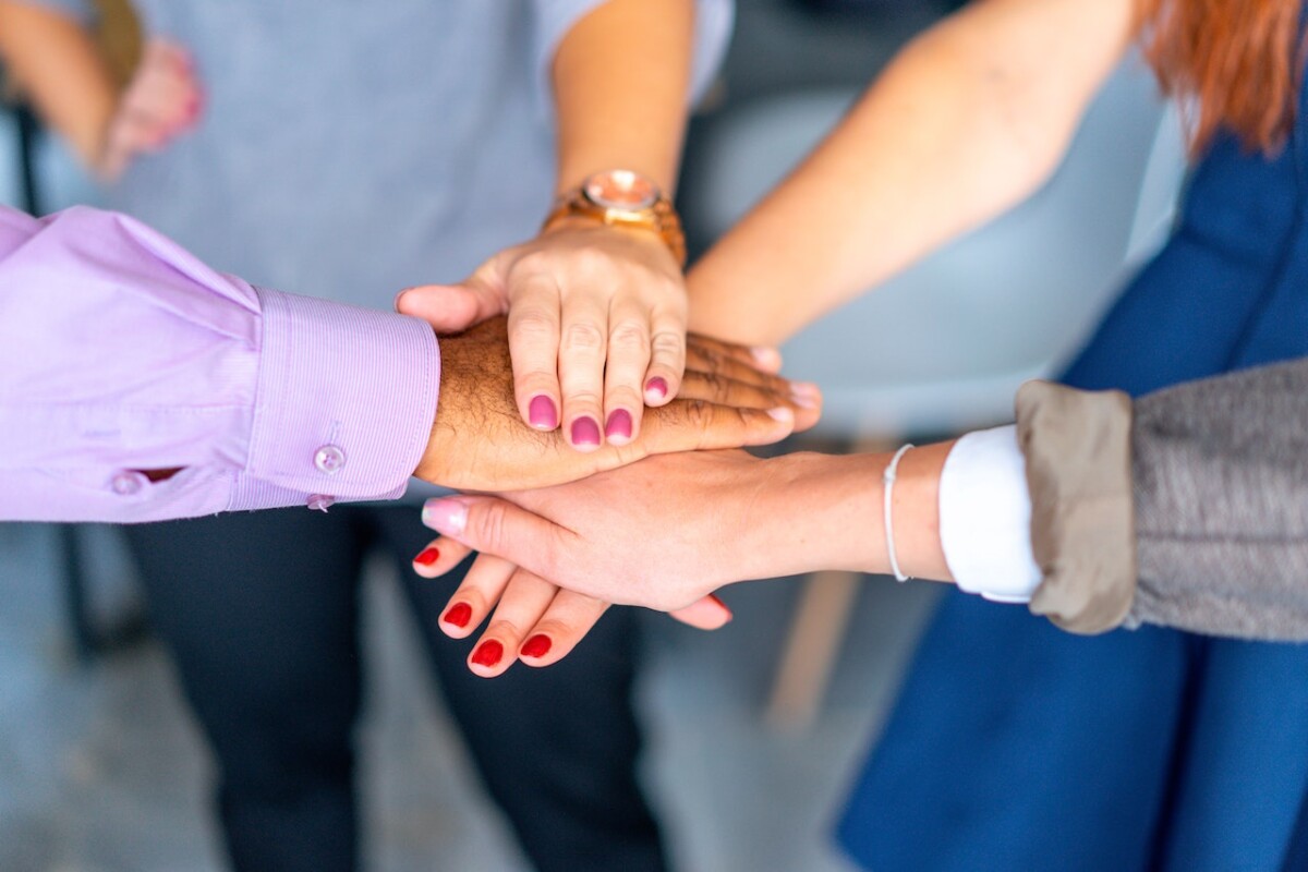 Hands placed on top of each other suggesting teamwork